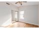 Bedroom with wood floors, a ceiling fan, and mirrored closet doors at 20929 N 37Th Way, Phoenix, AZ 85050