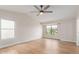 Spacious bedroom with wood floors, a ceiling fan, and large windows offering natural light at 20929 N 37Th Way, Phoenix, AZ 85050