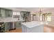 Well-lit kitchen with stainless steel appliances, an island, and stylish green cabinetry at 20929 N 37Th Way, Phoenix, AZ 85050