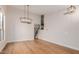 Open-concept living space with wood flooring, staircase, and contemporary lighting at 20929 N 37Th Way, Phoenix, AZ 85050