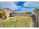 Wide backyard showcasing well-kept lawn, patio seating, and mature landscaping, perfect for outdoor enjoyment at 20977 N 84Th Ln, Peoria, AZ 85382