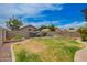 Spacious backyard with lush lawn, stone perimeter, landscaping, and a privacy fence at 20977 N 84Th Ln, Peoria, AZ 85382