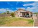 Well-maintained backyard featuring lush green grass, patio seating area, and mature landscaping at 20977 N 84Th Ln, Peoria, AZ 85382