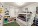 bedroom featuring a built-in bunk bed and shelving for toys and personal items at 20977 N 84Th Ln, Peoria, AZ 85382