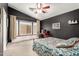 Stylish bedroom features a large window, dark accent wall, and cozy bay window seat at 20977 N 84Th Ln, Peoria, AZ 85382