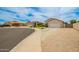 Residential street featuring well-maintained homes with desert landscaping, and two car garages at 20977 N 84Th Ln, Peoria, AZ 85382