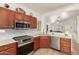 Well-lit kitchen featuring stainless steel appliances, granite countertops, and backsplash at 20977 N 84Th Ln, Peoria, AZ 85382