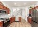 Modern kitchen with stainless steel appliances, sleek countertops, and an open layout to the living area at 20977 N 84Th Ln, Peoria, AZ 85382