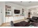 Open-concept living room with custom built-ins, modern decor, and plush seating area at 20977 N 84Th Ln, Peoria, AZ 85382