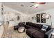 Spacious living room with a large sectional sofa, stylish decor, and open access to other living spaces at 20977 N 84Th Ln, Peoria, AZ 85382