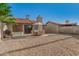 This backyard features gravel, a concrete patio, and table with umbrella for entertaining at 2154 E Forge Ave, Mesa, AZ 85204
