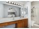 Well-lit bathroom showcasing a vanity, a framed mirror, and a glass-enclosed shower at 2154 E Forge Ave, Mesa, AZ 85204