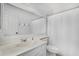 Bathroom with an expansive mirror over a vanity, toilet, and a white shower curtain at 2154 E Forge Ave, Mesa, AZ 85204