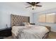 Cozy bedroom featuring a large headboard, patterned bedding, and natural light at 2154 E Forge Ave, Mesa, AZ 85204