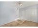 An empty bedroom with carpet, slider closet, and a ceiling fan at 2154 E Forge Ave, Mesa, AZ 85204