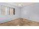 Neutral bedroom with a window letting in natural light, carpet flooring, and electrical outlets at 2154 E Forge Ave, Mesa, AZ 85204