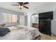 Comfortable bedroom with a ceiling fan, and a bathroom vanity behind an arched doorway at 2154 E Forge Ave, Mesa, AZ 85204