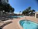 Community pool and hot tub area with ample lounge seating and mature trees at 2154 E Forge Ave, Mesa, AZ 85204