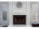 Close-up of a white fireplace with a decorative clock and flanking windows at 2154 E Forge Ave, Mesa, AZ 85204