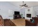Bright living room featuring a fireplace, ceiling fan, and comfortable seating at 2154 E Forge Ave, Mesa, AZ 85204