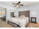 Comfortable main bedroom with a large bed, mirrored closet, and a ceiling fan at 2154 E Forge Ave, Mesa, AZ 85204