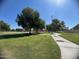 Community park with open green space, playground, and walking paths for outdoor enjoyment at 2154 E Forge Ave, Mesa, AZ 85204