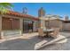 Inviting outdoor patio with dining area and lush landscaping, ideal for relaxing or entertaining guests at 2154 E Forge Ave, Mesa, AZ 85204