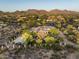 Aerial view of the home nestled in desert landscape with mountain views at 22022 N Calle Royale Dr, Scottsdale, AZ 85255