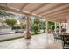 Inviting covered patio overlooking a pool, waterfall feature, and landscaped backyard at 22022 N Calle Royale Dr, Scottsdale, AZ 85255