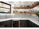 Stylish bar area boasting floral wallpaper, wine fridge, floating shelves and ample liquor storage at 22022 N Calle Royale Dr, Scottsdale, AZ 85255