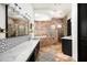 Bathroom featuring dual sinks, stone-tiled walls, and a separate tub and shower at 22022 N Calle Royale Dr, Scottsdale, AZ 85255
