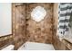 Beautiful bathroom featuring travertine tile, a tub, shower, and a decorative window above the tub at 22022 N Calle Royale Dr, Scottsdale, AZ 85255