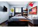 Stylized bedroom with a dark wood bed frame, blue walls, and eclectic decor at 22022 N Calle Royale Dr, Scottsdale, AZ 85255
