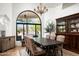 Elegant dining room with natural light and seating for six featuring a decorative china cabinet at 22022 N Calle Royale Dr, Scottsdale, AZ 85255