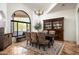 Elegant dining room with natural light and seating for six featuring a decorative china cabinet at 22022 N Calle Royale Dr, Scottsdale, AZ 85255