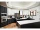 Modern kitchen with stainless steel appliances, white backsplash, and dual-tone cabinetry at 22022 N Calle Royale Dr, Scottsdale, AZ 85255