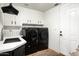Functional laundry room with white cabinets, modern washer and dryer, and a sink at 22022 N Calle Royale Dr, Scottsdale, AZ 85255