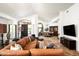 Spacious living room featuring travertine floors, leather sofa, and views into dining area at 22022 N Calle Royale Dr, Scottsdale, AZ 85255