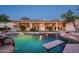 Inviting backyard pool with baja shelf and spa overlooking the covered patio of this luxury home at 22022 N Calle Royale Dr, Scottsdale, AZ 85255