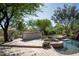 Entertaining poolside bar and hot tub area surrounded by mature landscaping at 22022 N Calle Royale Dr, Scottsdale, AZ 85255