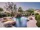 Stunning pool with a waterfall feature, lush landscaping, and a spa at 22022 N Calle Royale Dr, Scottsdale, AZ 85255