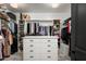 Organized walk-in closet with ample storage, shelving, and a central dresser at 22022 N Calle Royale Dr, Scottsdale, AZ 85255