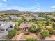 Expansive aerial view showcases lush landscaping, circular driveway, and mountain views at 2285 E Plum St, Gilbert, AZ 85298