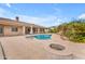 Beautiful backyard features a pool with a rock waterfall, fire pit and covered patio for entertaining at 2285 E Plum St, Gilbert, AZ 85298