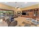 Inviting living room with a cozy fireplace, entertainment center, and views of the pool at 2285 E Plum St, Gilbert, AZ 85298