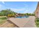 Resort-style pool area with rock waterfall feature, lush landscaping, and ample space to relax at 2285 E Plum St, Gilbert, AZ 85298