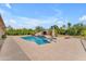 Inviting backyard pool with rock waterfall feature and desert landscaping creates a private oasis at 2285 E Plum St, Gilbert, AZ 85298