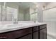 This bathroom features a double vanity and a glass shower at 22895 N 183Rd Dr, Surprise, AZ 85387