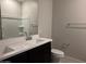 Modern bathroom with double sinks, a large mirror, and sleek fixtures at 22895 N 183Rd Dr, Surprise, AZ 85387