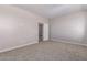 A bright bedroom with neutral walls, carpet flooring, and a walk-in closet at 22895 N 183Rd Dr, Surprise, AZ 85387